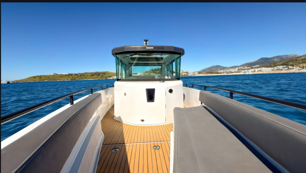 Axopar 28 Bodrum luggage space and rear passenger seating area with spacious teak deck, comfortable outdoor benches, panoramic sea views, and practical storage capacity for VIP Bodrum to Kos speedboat transfers and Greek island luxury travel.