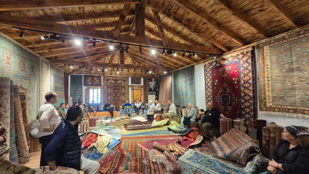 Etrim Village Carpet workshop near Bodrum featuring traditional Turkish carpet weaving, handmade rugs, authentic village culture, local artisans, and rustic stone house atmosphere in Turkey.