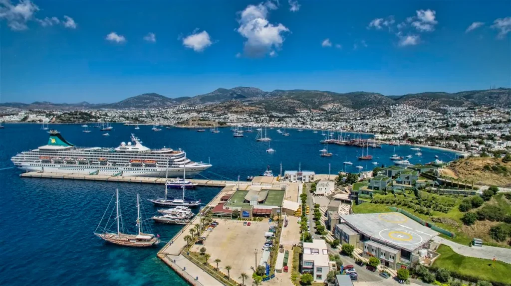 Bodrum Helicopter Tours 2026 – Luxury Airbus H130 helicopter tour over Bodrum Peninsula, offering breathtaking aerial views of turquoise bays, luxury resorts, marinas, and the Aegean coastline with Tesla Travel.
